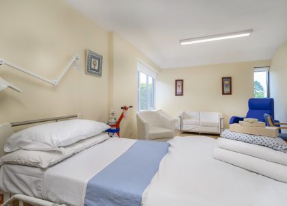 A private hospital room with fresh towels and gown