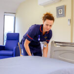 New Foscote nurse preparing a patients bed