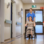 Foscote Hospital nurse helping a patient in a wheelchair