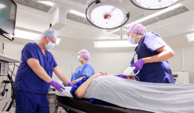 surgeons with patient in New Fostcote Hospital Theatre